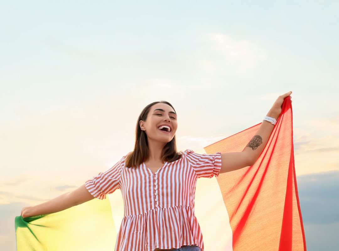 Young woman with Italian flag outdoors Young woman with Italian flag outdoors