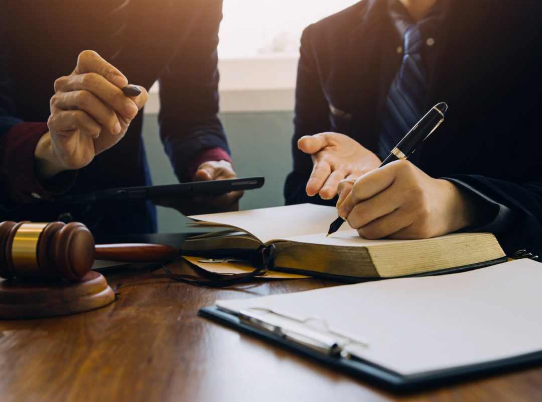 Businessman and Male lawyer or judge consult having team meeting Businessman and Male lawyer or judge consult having team meeting with client, Law and Legal services concept.