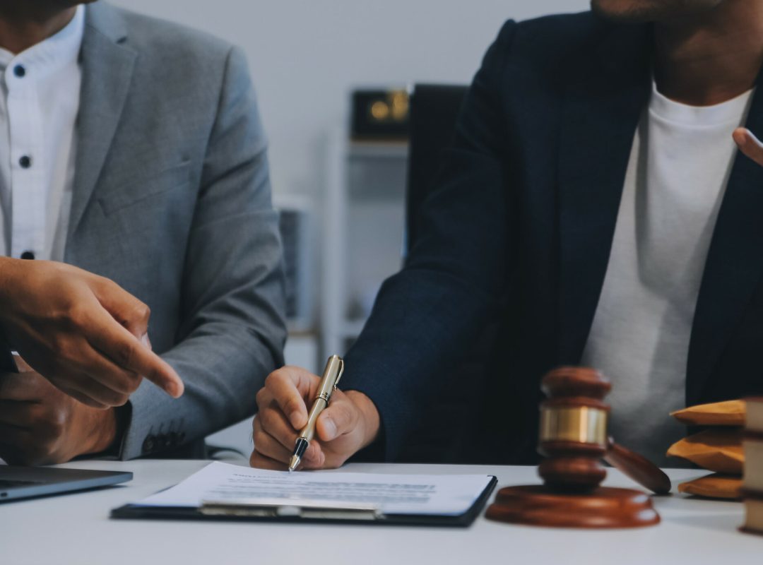 Consultation and conference of Male lawyers and professional bus Consultation and conference of Male lawyers and professional businesswoman working and discussion having at law firm in office. Concepts of law, Judge gavel with scales of justice.
